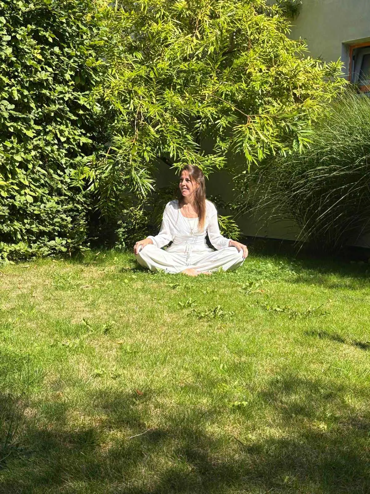 Aude meditating in a garden